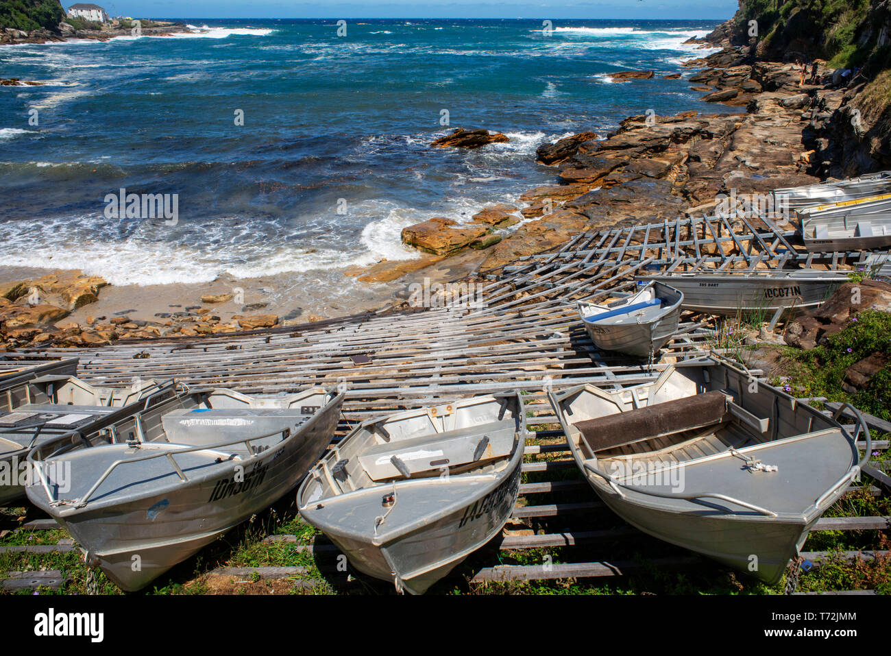 The Bondi beach to Coogee walk is a coastal walk in Sydney New South Wales, Australia. Boats in Gordons Bay. Stock Photo