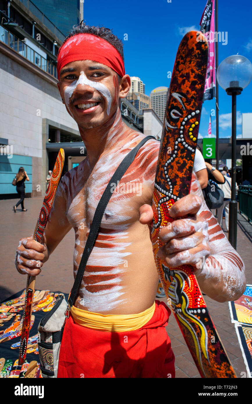 Australian Aboriginal dressed man selling boomerangs in The Rocks area at Circular Quay in Sydney New South Wales, Australia Stock Photo