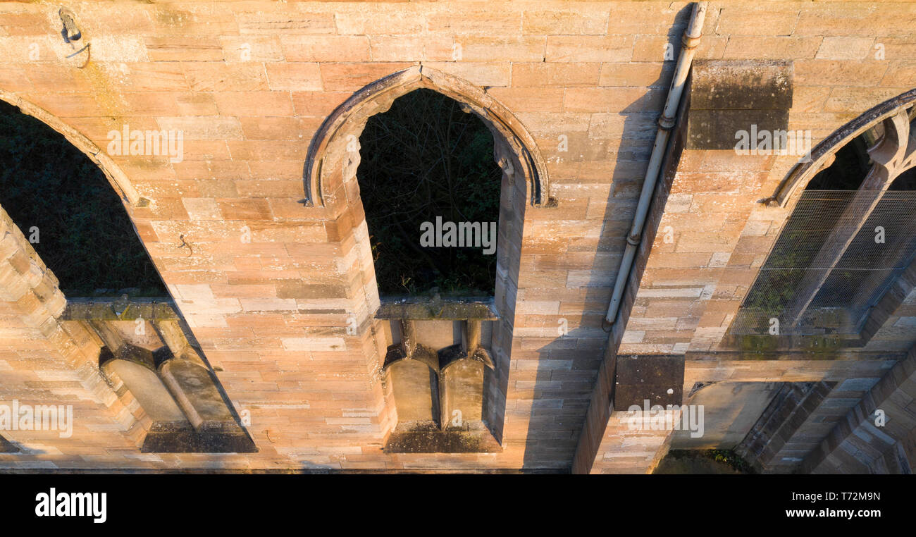 Drone view of wall of old stone church looking down Stock Photo - Alamy