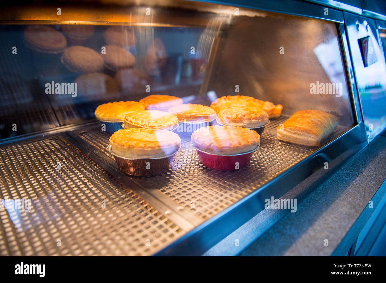 Traditional pies in a British traditional chip shop or chippy or Chippie Stock Photo
