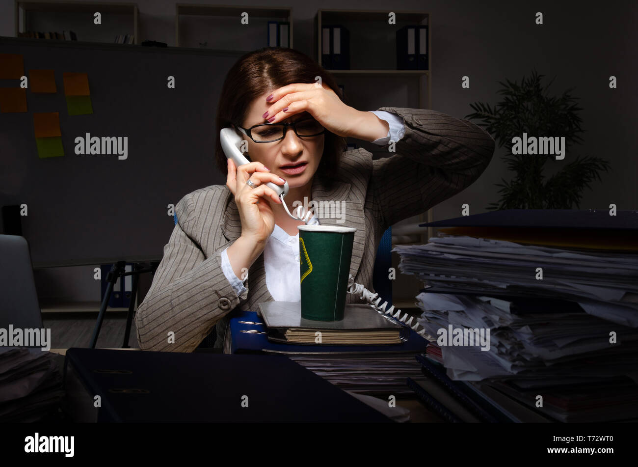 Female employee suffering from excessive work Stock Photo - Alamy