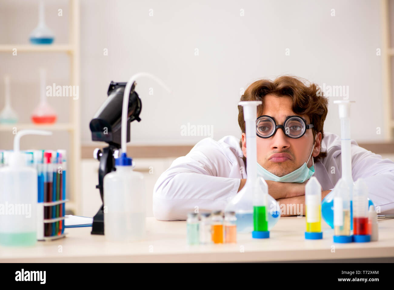 Funny crazy chemist doing experiments and tests Stock Photo