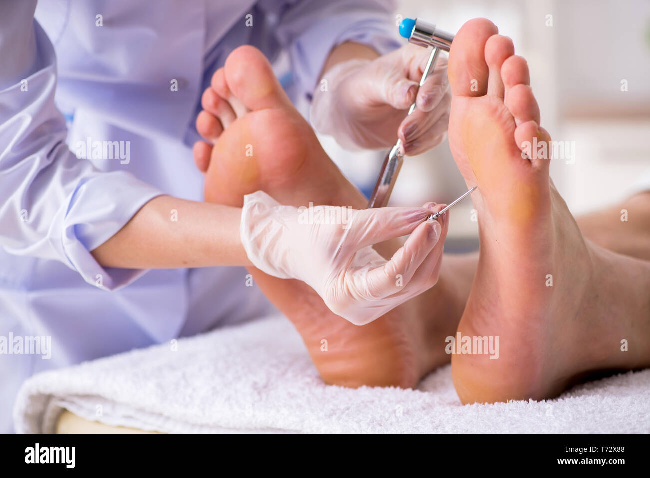 Podiatrist treating feet during procedure Stock Photo Alamy