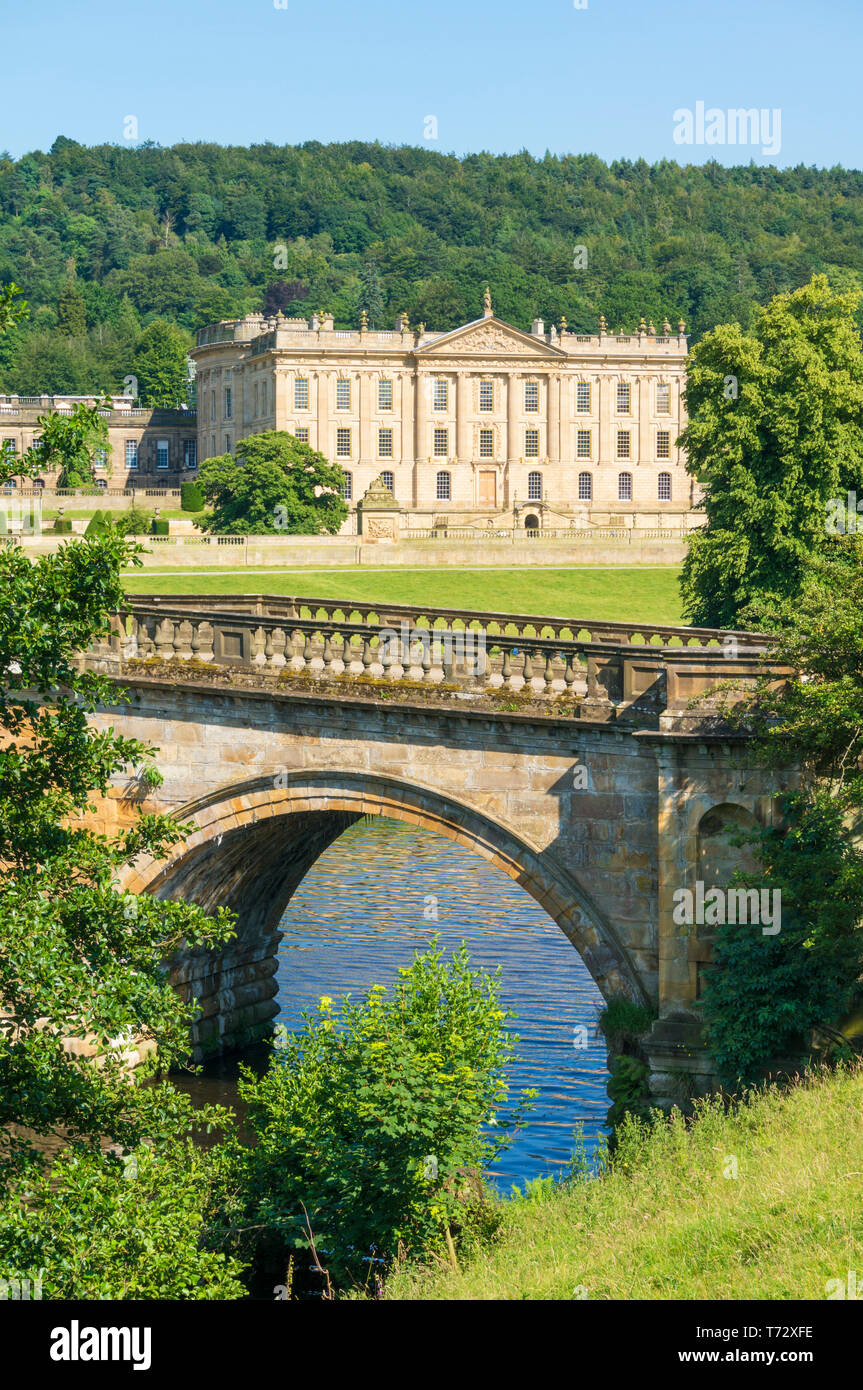 Chatsworth House park with an entrance bridge over the river Derwent parkland and woods Derbyshire England UK GB,  Europe Stock Photo