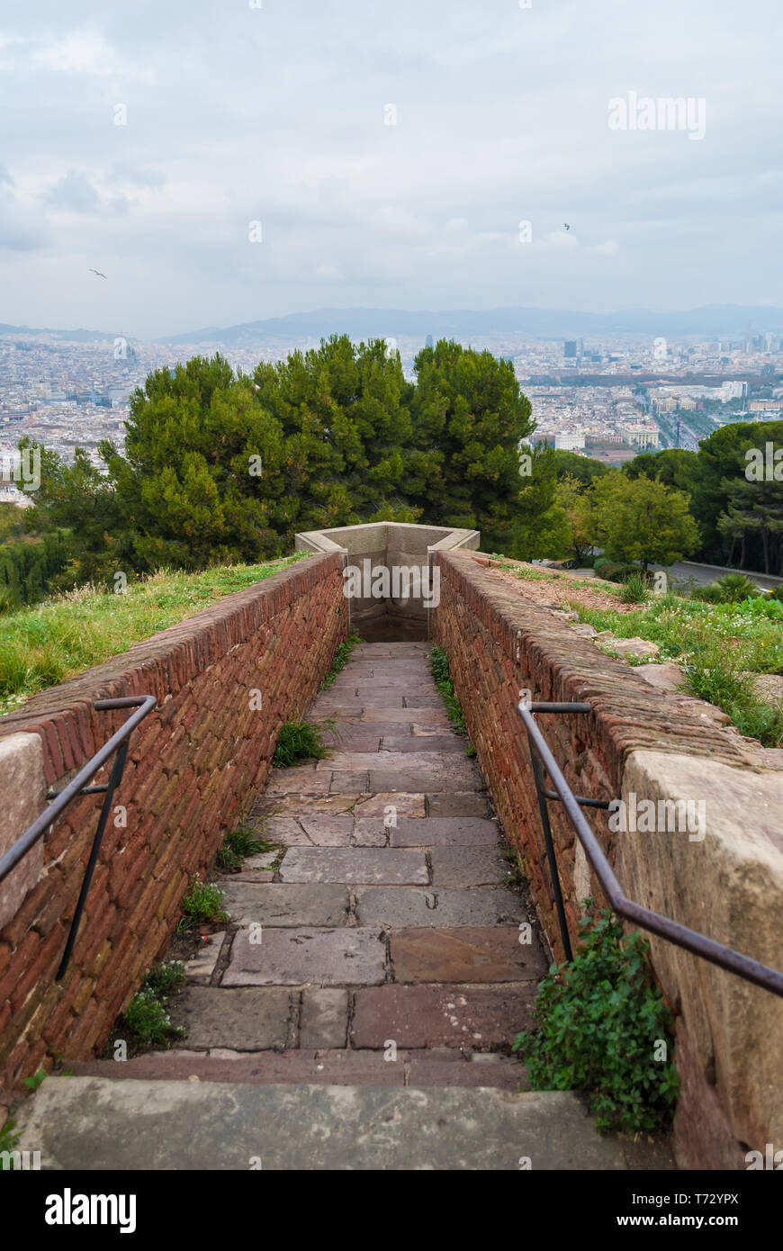 The passage to the sentinel point of the Montjuic Castle on the background of the Barcelona city, Spain Stock Photo