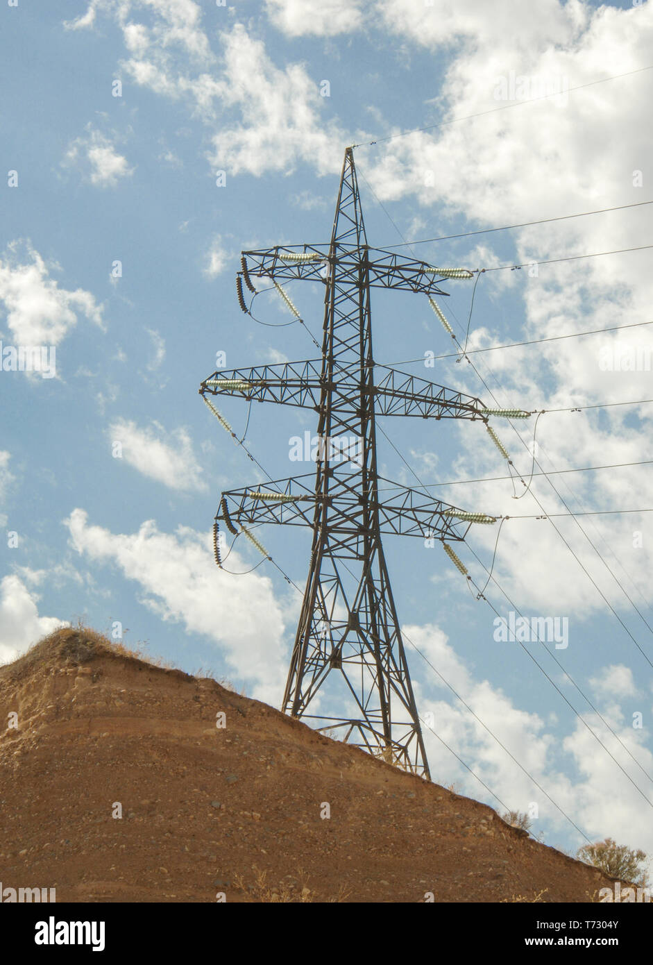 high voltage tower against the blue sky with clouds Stock Photo - Alamy