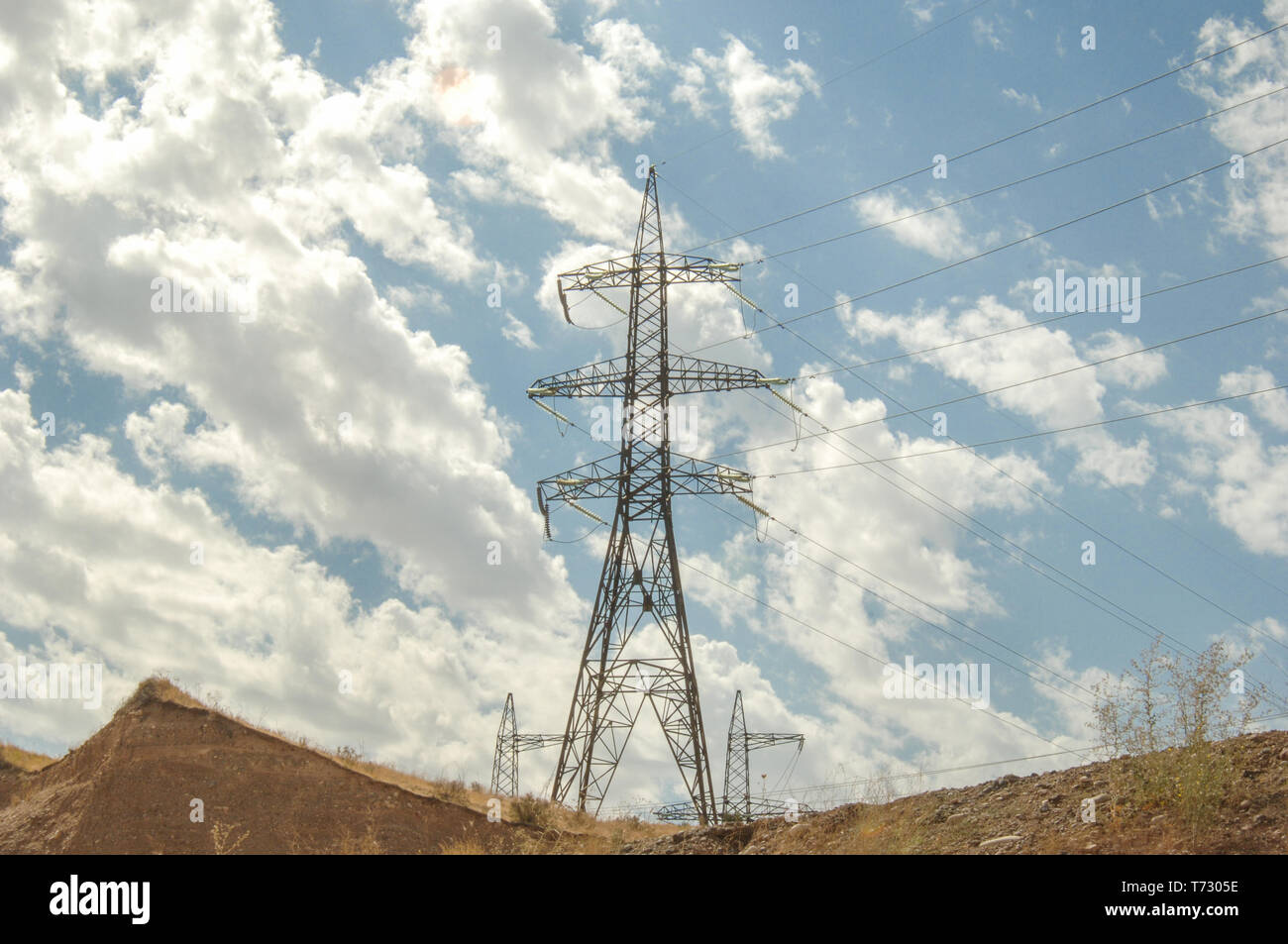 high voltage tower against the blue sky with clouds Stock Photo - Alamy