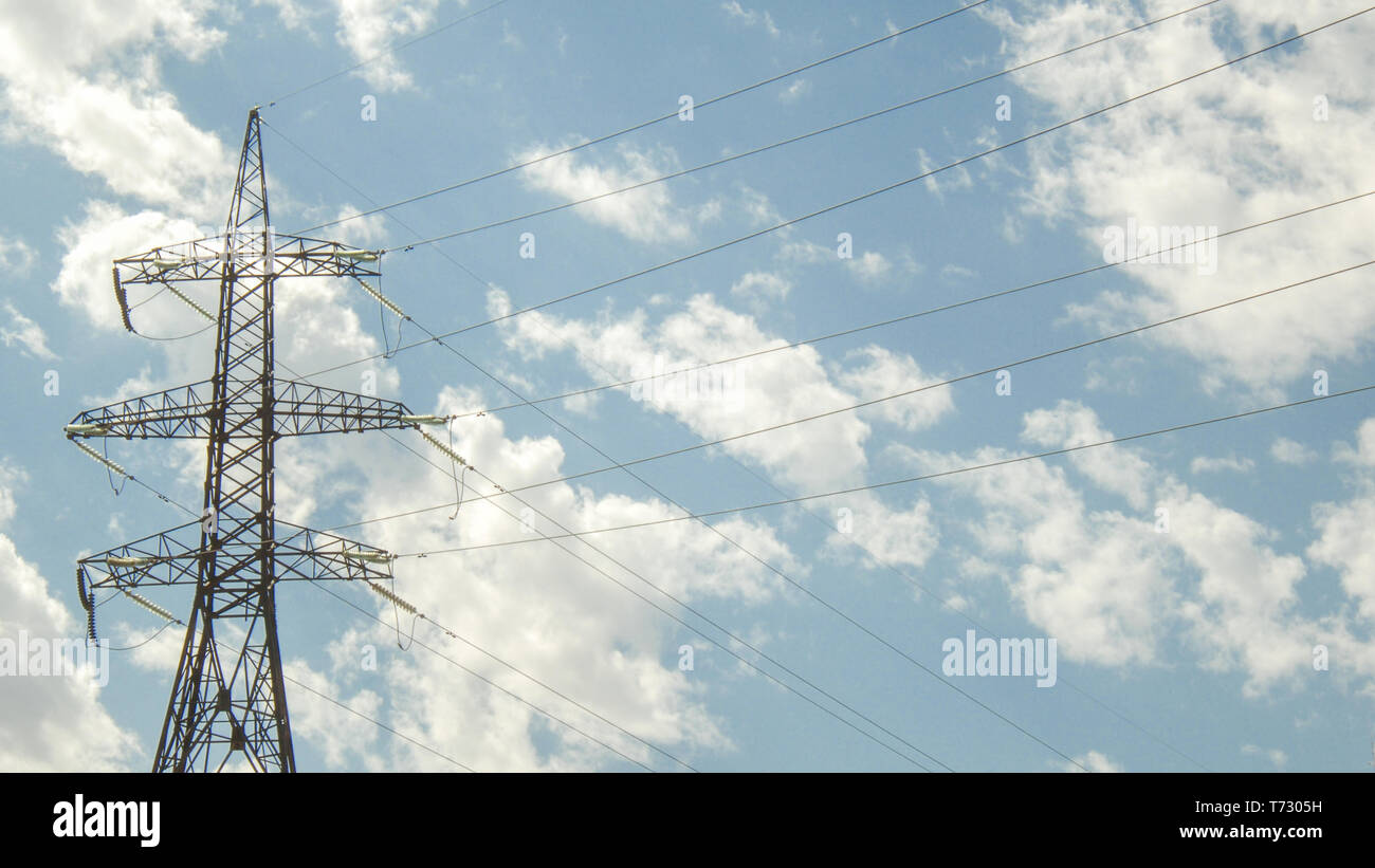 high voltage tower against the blue sky with clouds Stock Photo - Alamy