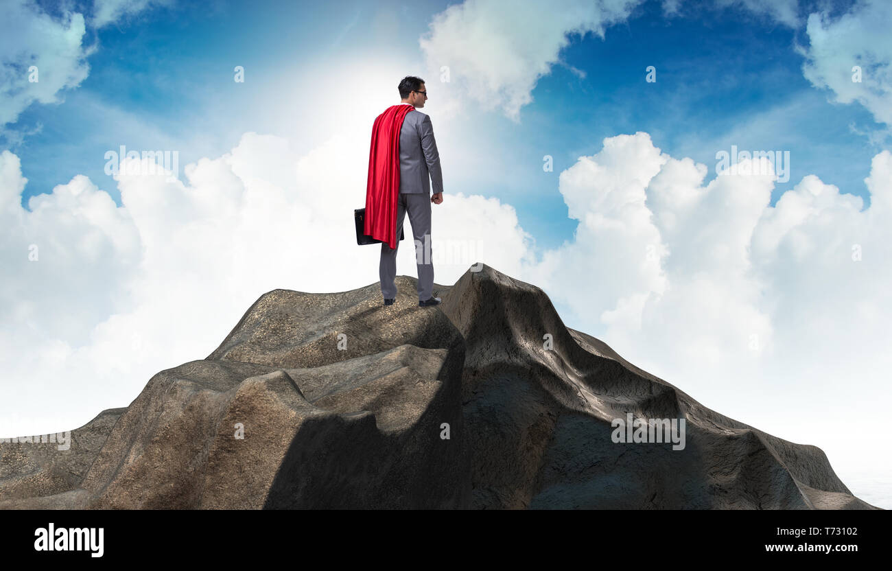 Superhero businessman on top of mountain Stock Photo - Alamy