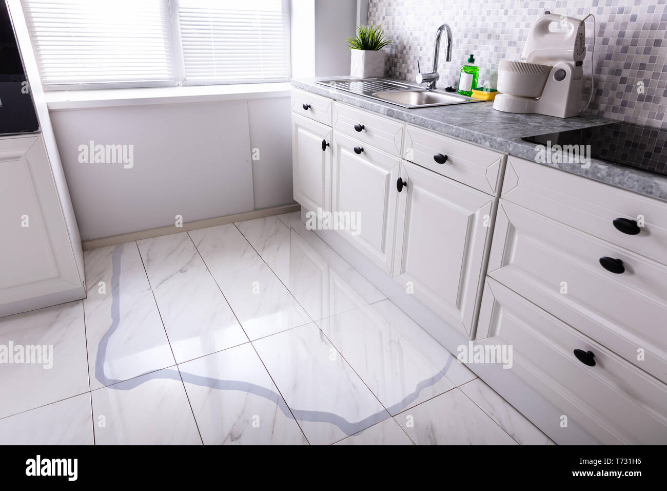 Closeup Of Spilled Water On Kitchen Floor At Home Stock Photo Alamy
