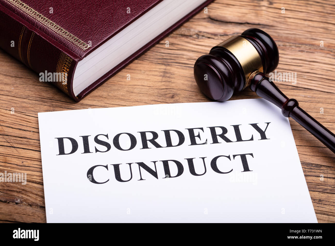 Disorderly Conduct Text On Legal Document Near Gavel And Law Book Over Wooden Desk Stock Photo