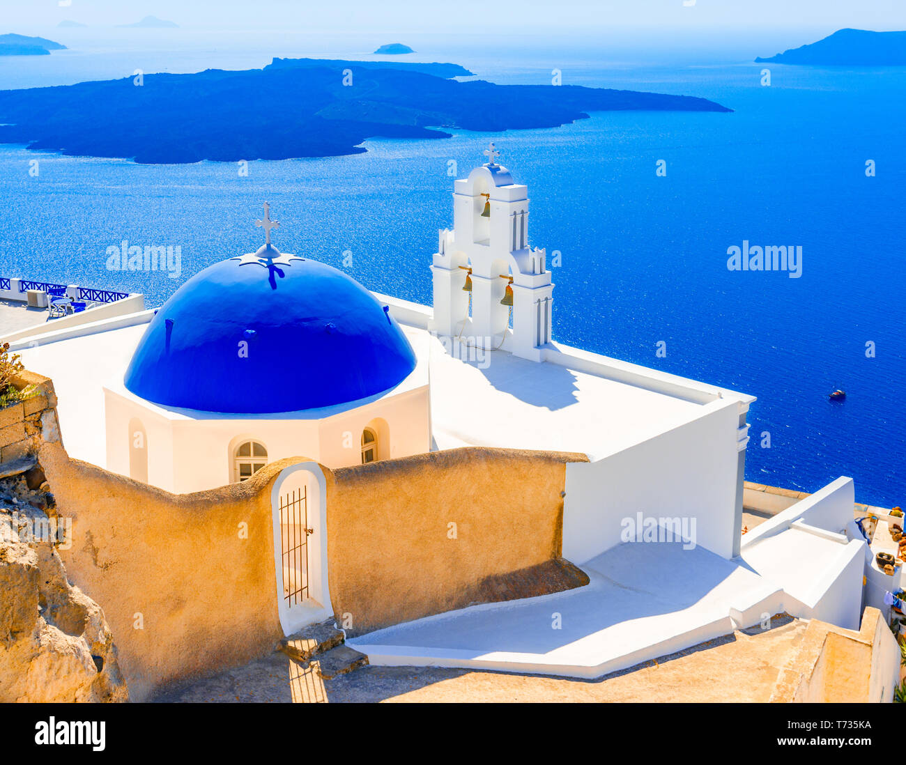 Firostefani, Santorini, Greece: Old greek church and caldera at Aegean Sea - Greek Islands landmark Stock Photo