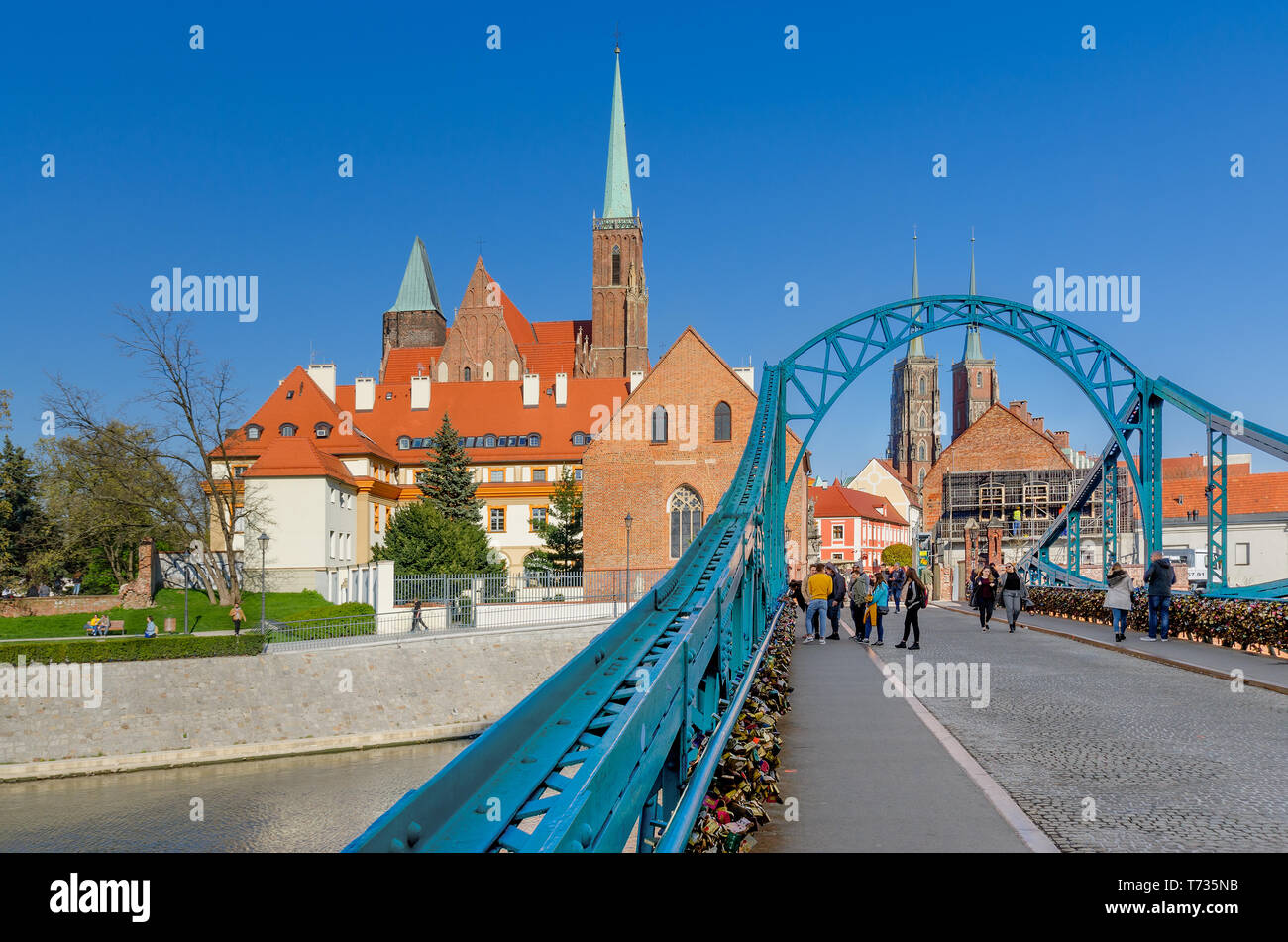 Wroclaw, Lower Silesian province, Poland. Tumski Bridge, leading to the Ostrow Tumski district. Belfries of the Collegiate Church of Holy Cross. Stock Photo