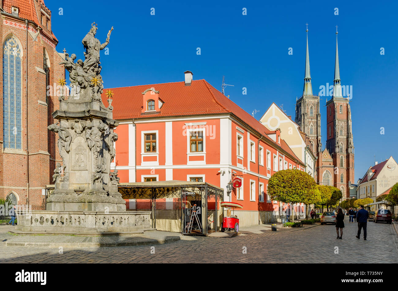 Wroclaw, Lower Silesian province, Poland. Church Square with John of Nepomuk statue. Belfries of the Cathedral of St. John Baptiste Stock Photo