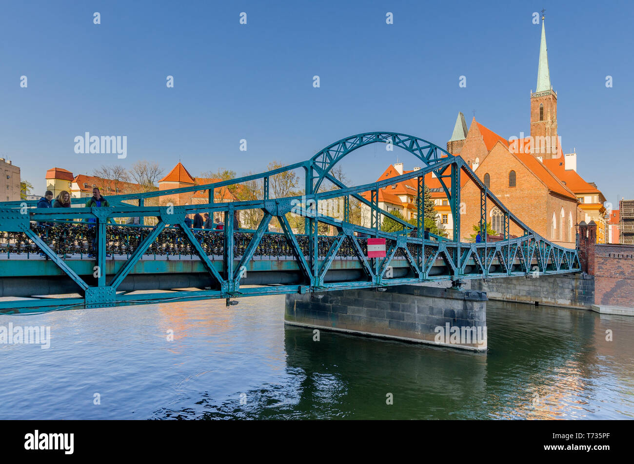 Wroclaw, Lower Silesian province, Poland. Tumski Bridge, leading to the Ostrow Tumski district. Belfries of the Collegiate Church of the Holy Cross. Stock Photo