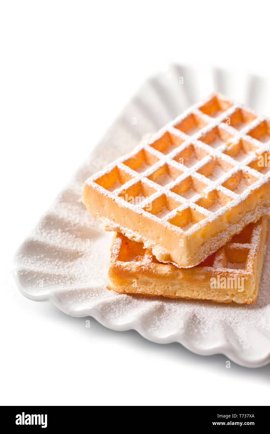 Belgium waffers with sugar powder on ceramic plate isolated on white ...