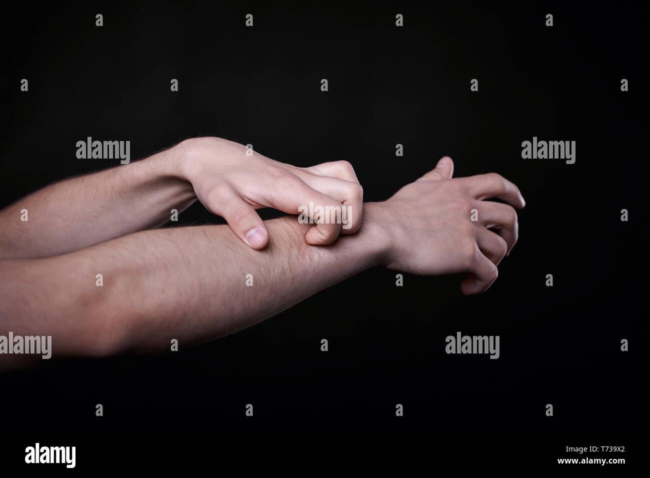 two beautiful man's hands in the dark Stock Photo