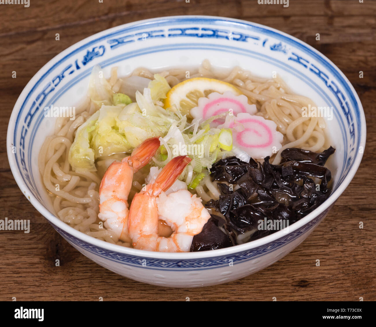 Ramen Shio with fish broth, shrimp, naruto Kamaboko, black mushrooms,  Chinese cabbage, dark wood table background Stock Photo - Alamy