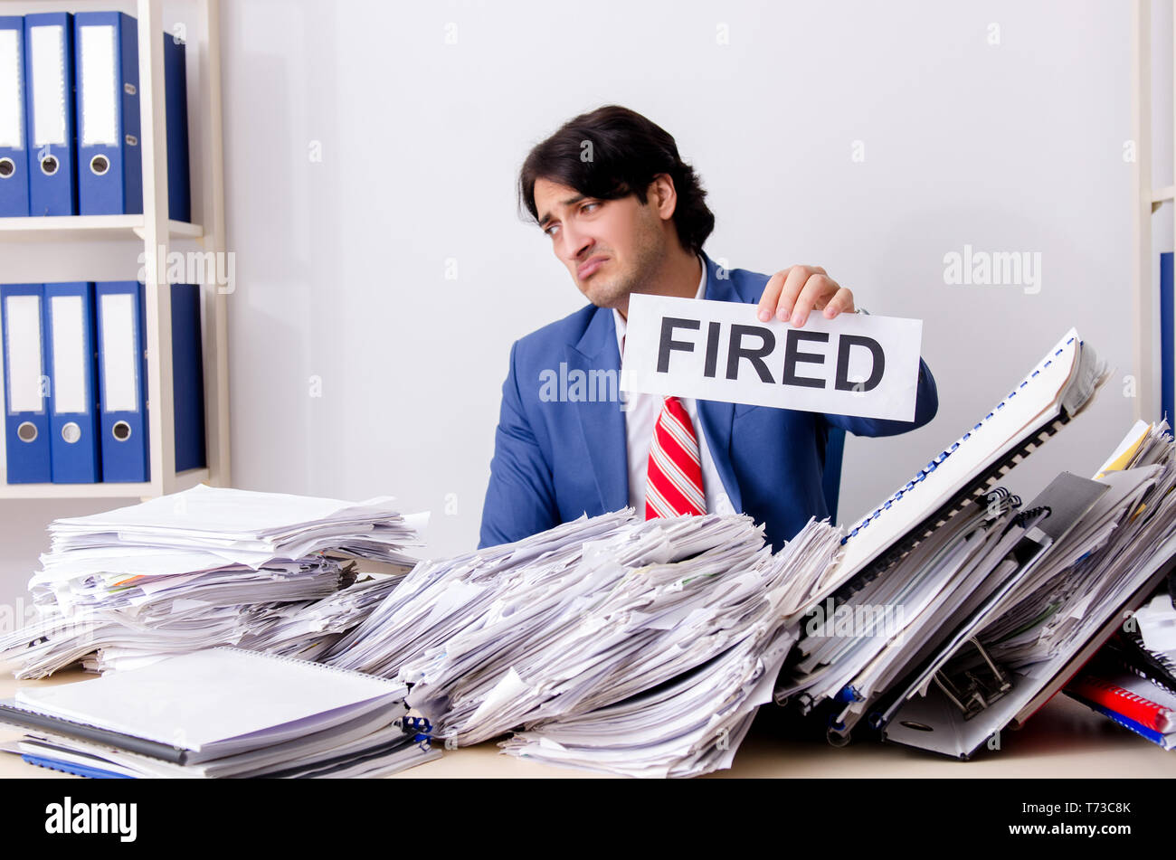 Young businessman employee unhappy with excessive work Stock Photo
