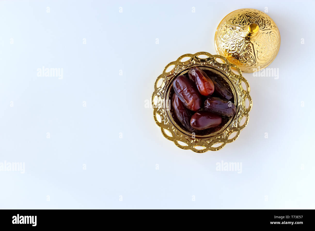 Organic dried dates in traditional arabic golden plate. Holy month