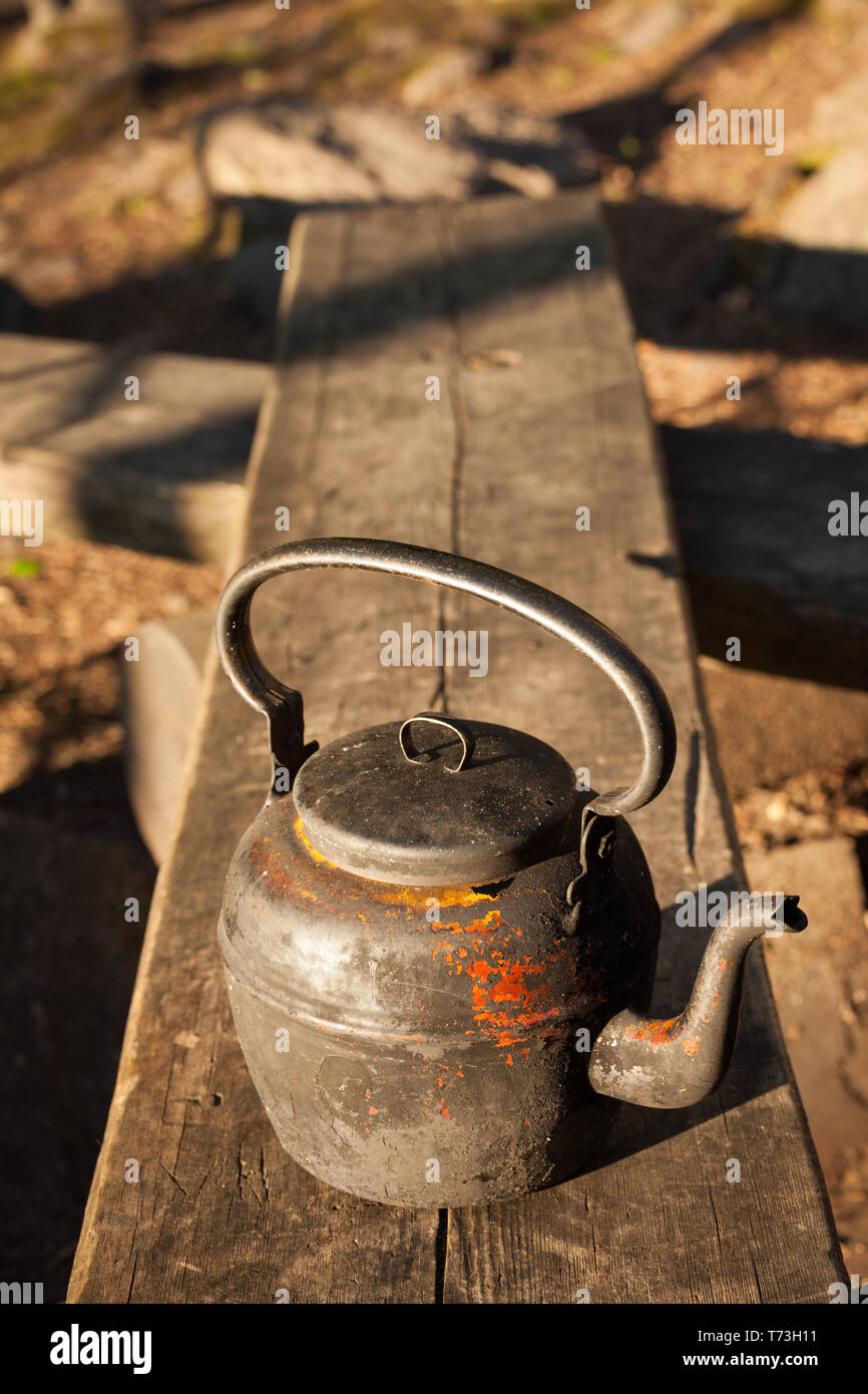 Old used metal camping kettle with plastic coated handle Stock Photo - Alamy