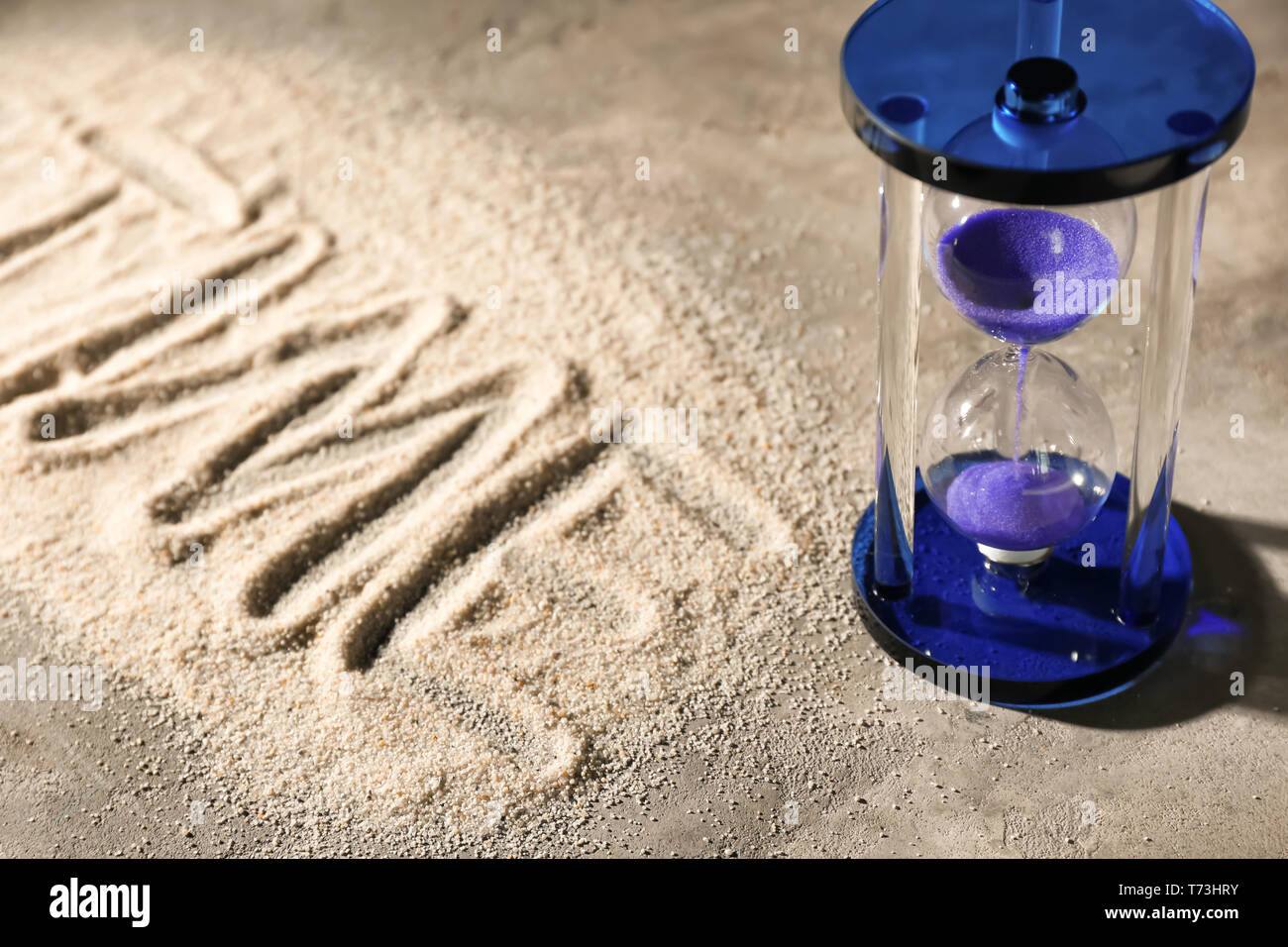 Hourglass on sand. Time management concept Stock Photo - Alamy
