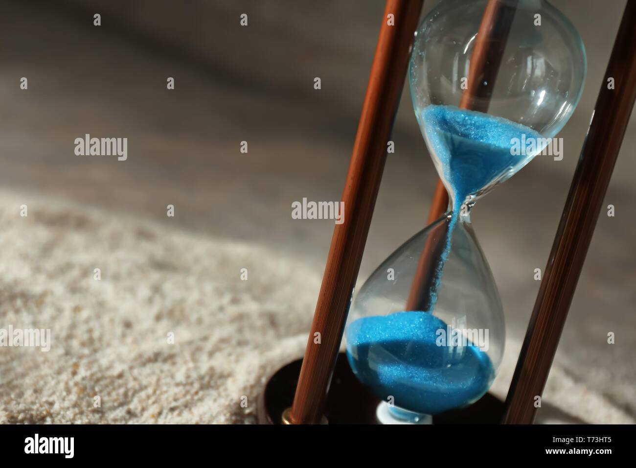 Hourglass on sand. Time management concept Stock Photo - Alamy