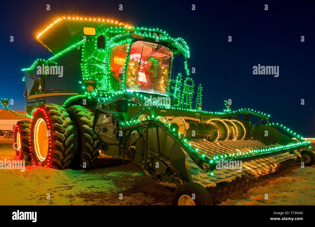 Combine harvester with Christmas lights; Manitoba, Canada Stock Photo Alamy