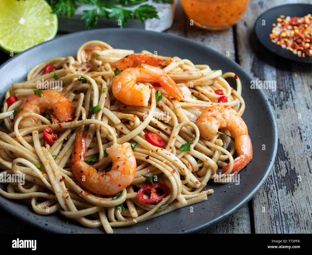 noodles pasta with shrimp , spice , on the plate. Closeup. Stock Photo