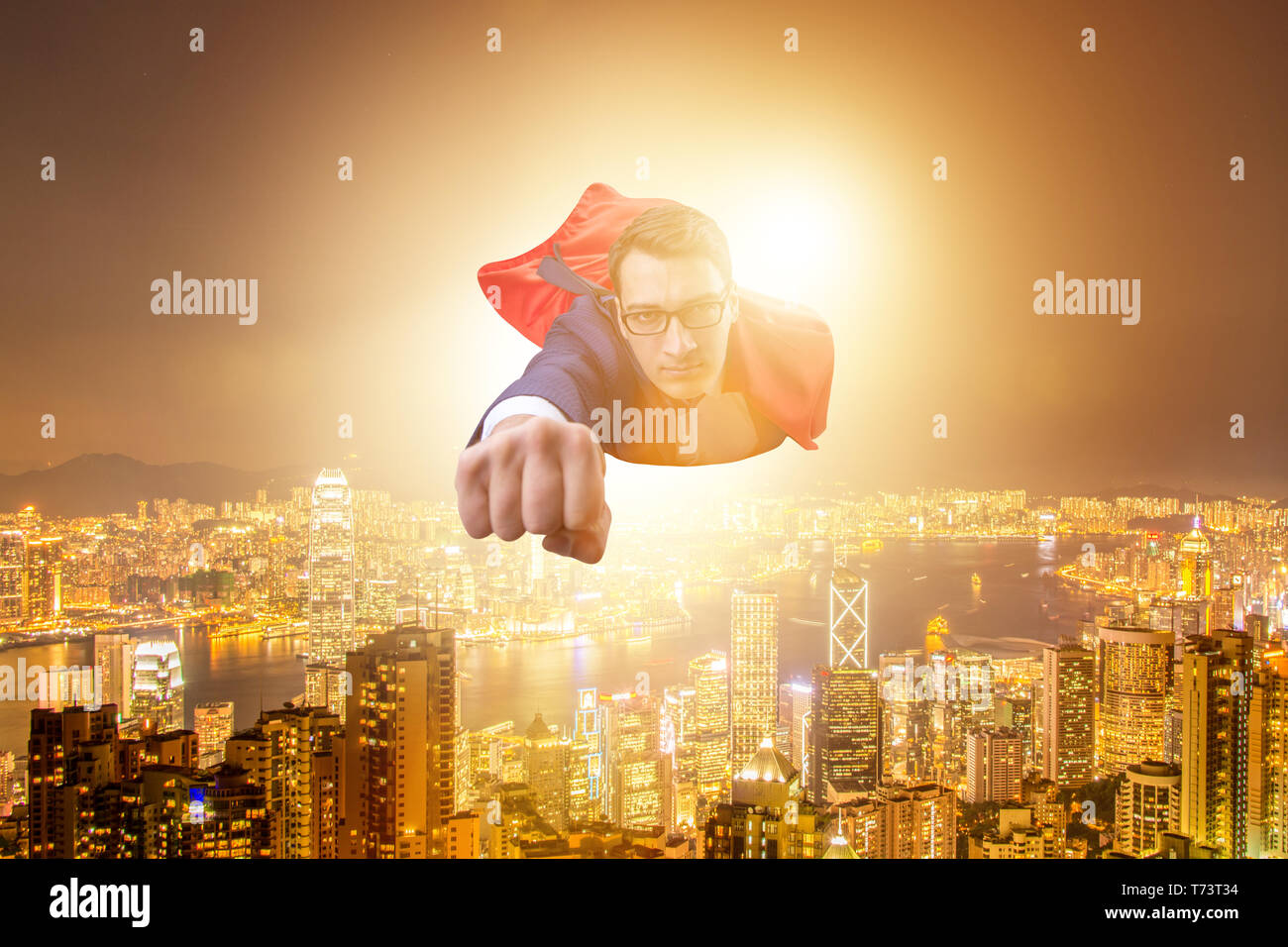 Superhero businessman flying over the city Stock Photo