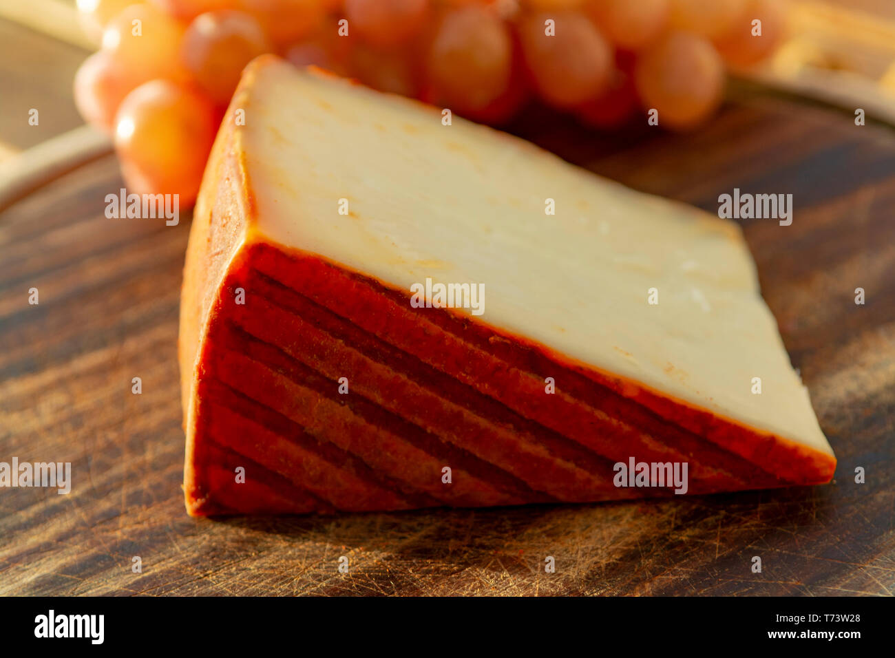 Spanish goat milk cheese with paprika coating and ripe pink table