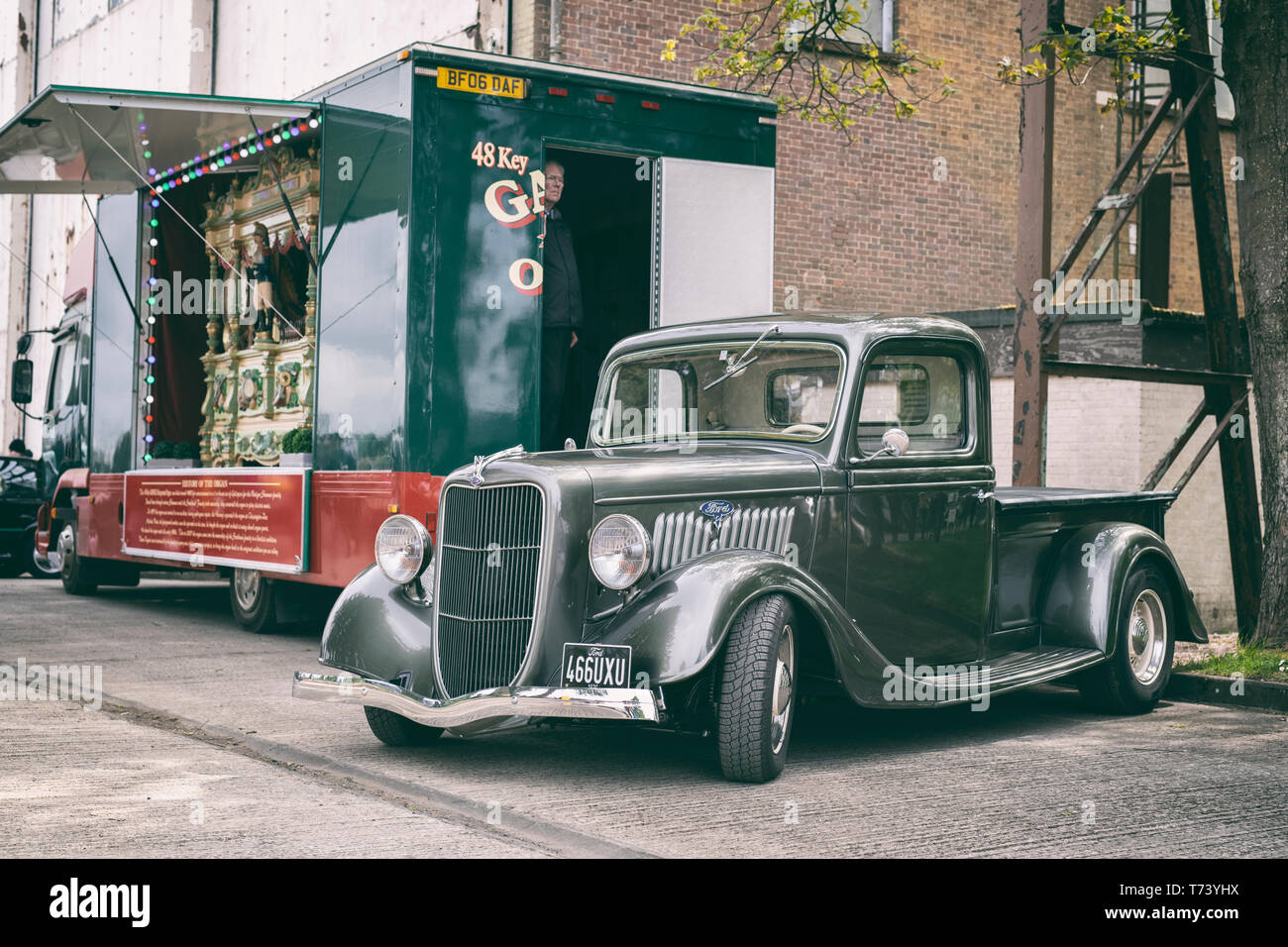 1936 Ford pick up truck in front of a Victorian fairground organ at Bicester heritage centre, 'Drive It Day'. Bicester, Oxfordshire, England. Stock Photo