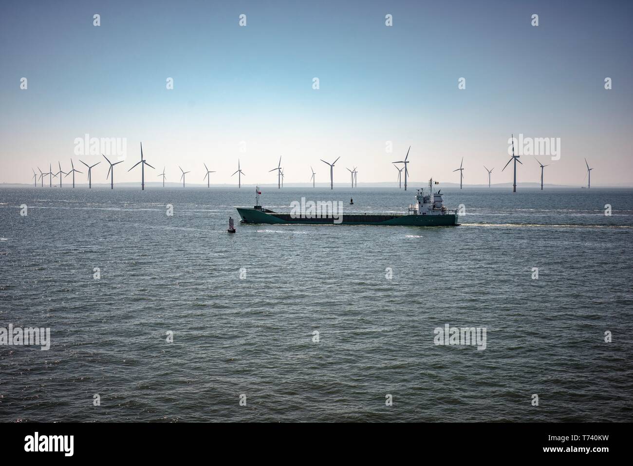Ship passing wind turbines Stock Photo