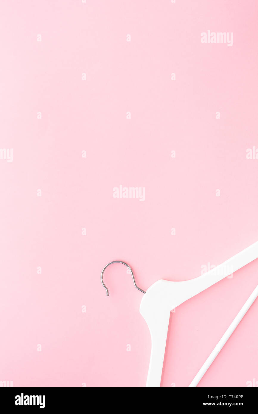 Creative top view flat lay white wooden hangers pastel millennial pink ...