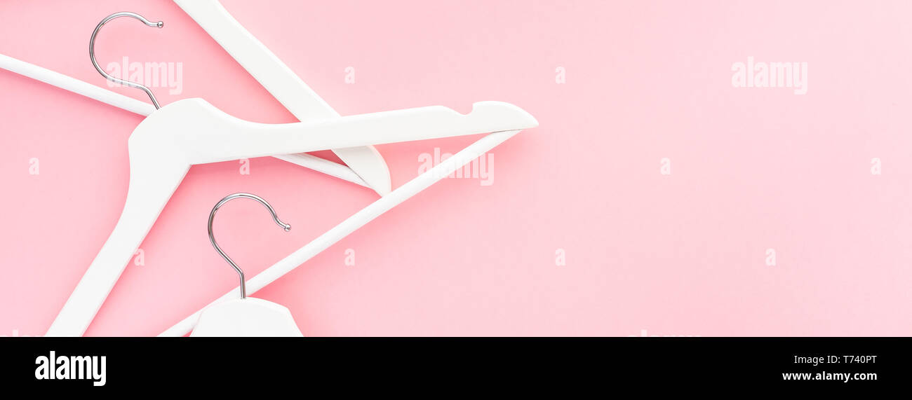 Creative top view flat lay white wooden hangers pastel millennial pink ...