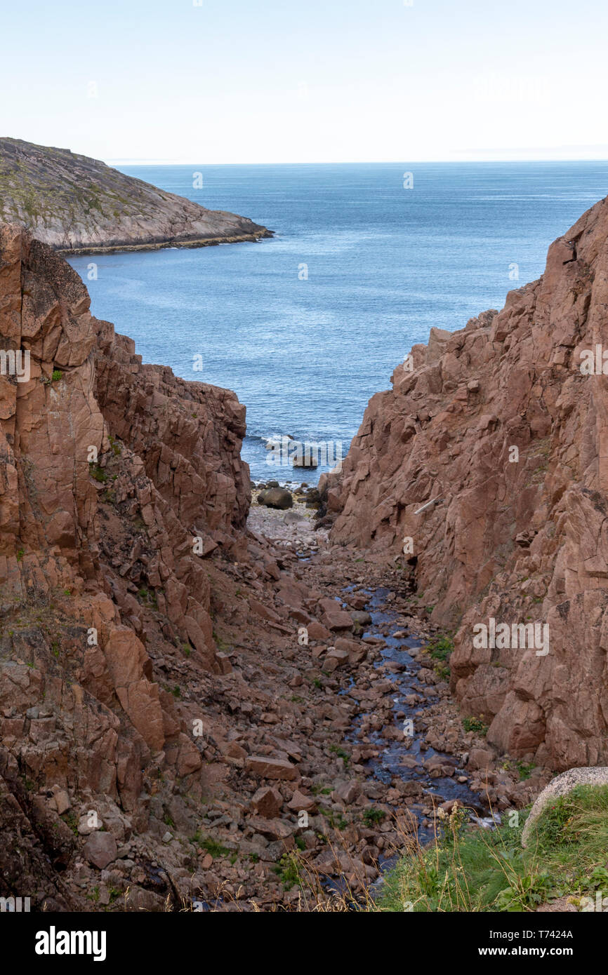 River Meets Ocean Along A Rocky Shoreline With Heavy Water Flow In A 