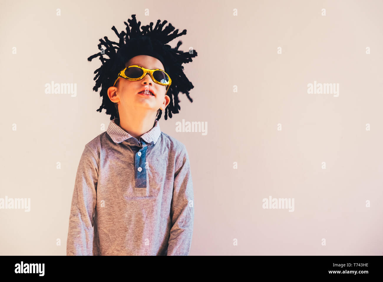 Child with rastafari wig dancing cheerful, isolated copy space white background Stock Photo Alamy