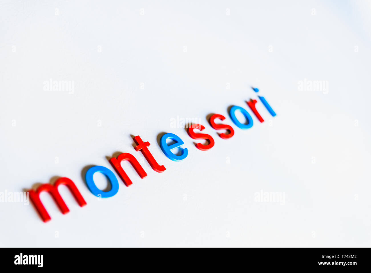 Montessori word written with colorful letters on white background Stock