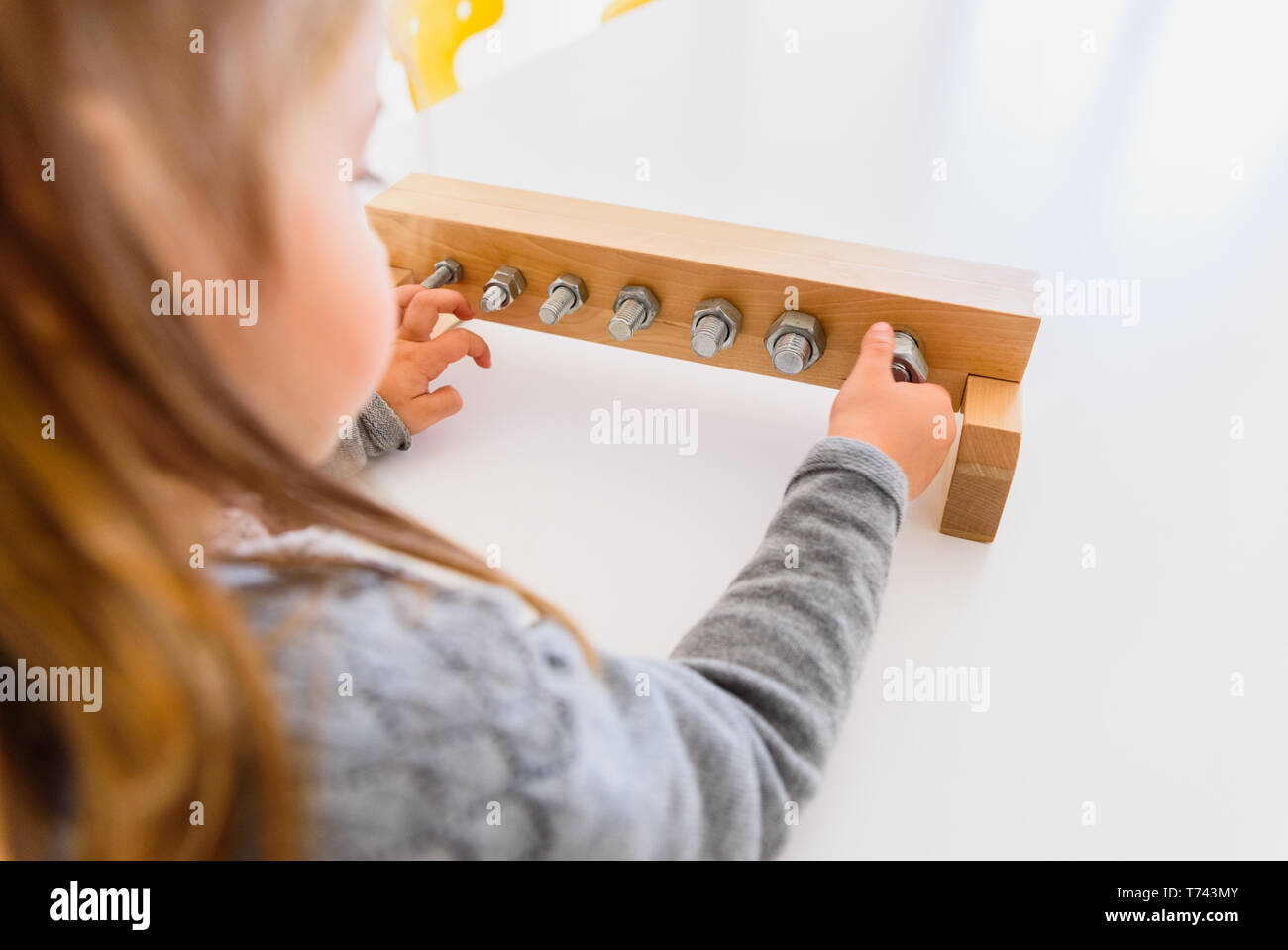 Girl handling tools to tighten nuts and bolts Stock Photo Alamy