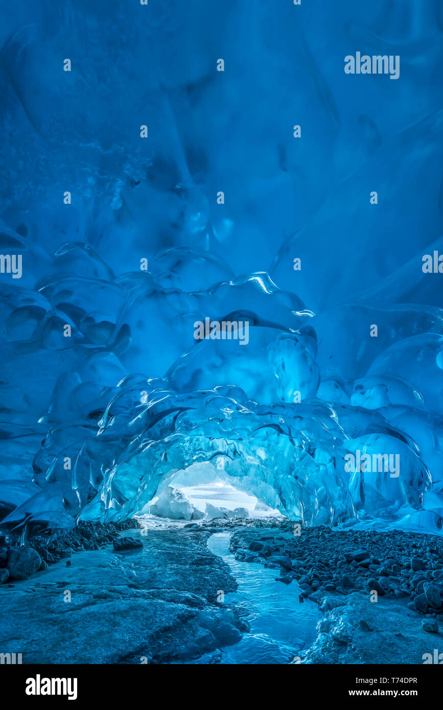 A stream flows beneath an ice cave on Mendenhall Glacier, Tongass National Forest; Alaska, United States of America Stock Photo