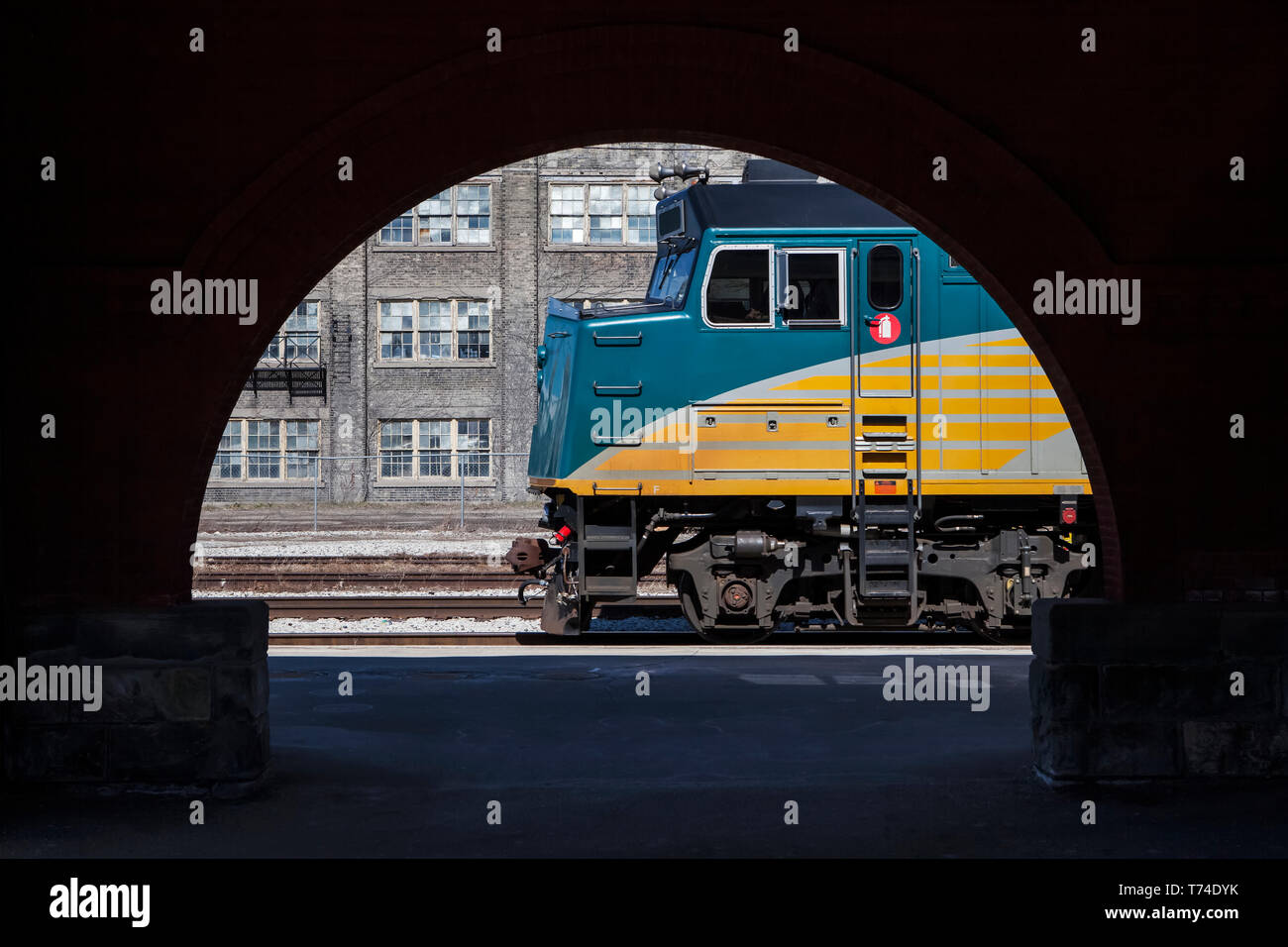 Passenger train locomotive, framed by station archway; Kitchener, Ontario, Canada Stock Photo