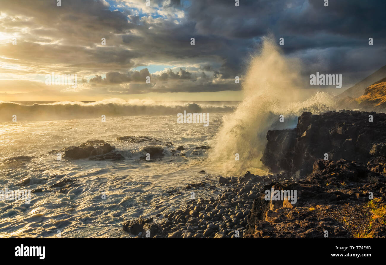 Waves crashing against the shoreline at sunset along the Western coast of Oahu; Oahu, Hawaii, United States of America Stock Photo
