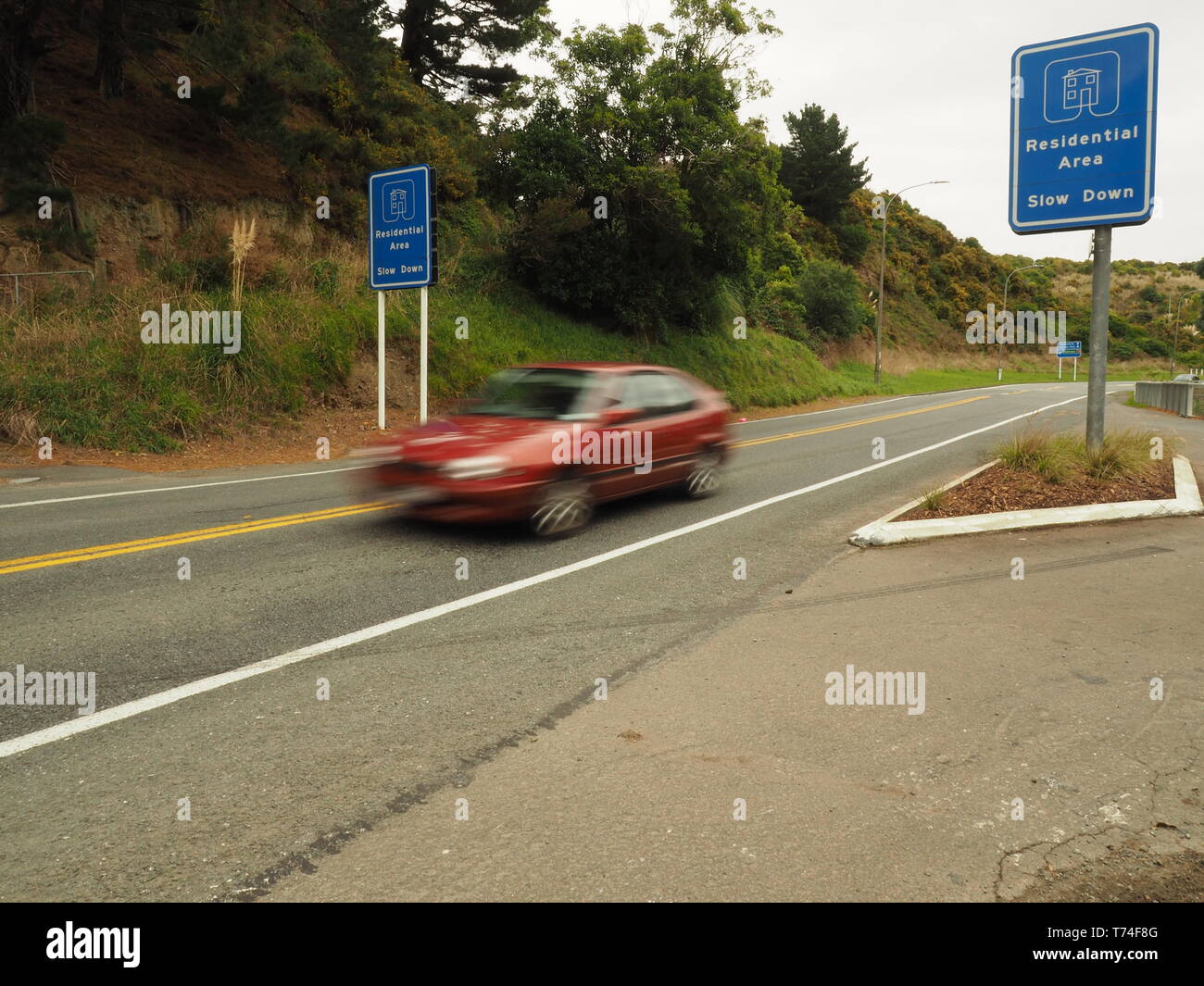 Car speeding through a residential zone in the suburbs Stock Photo