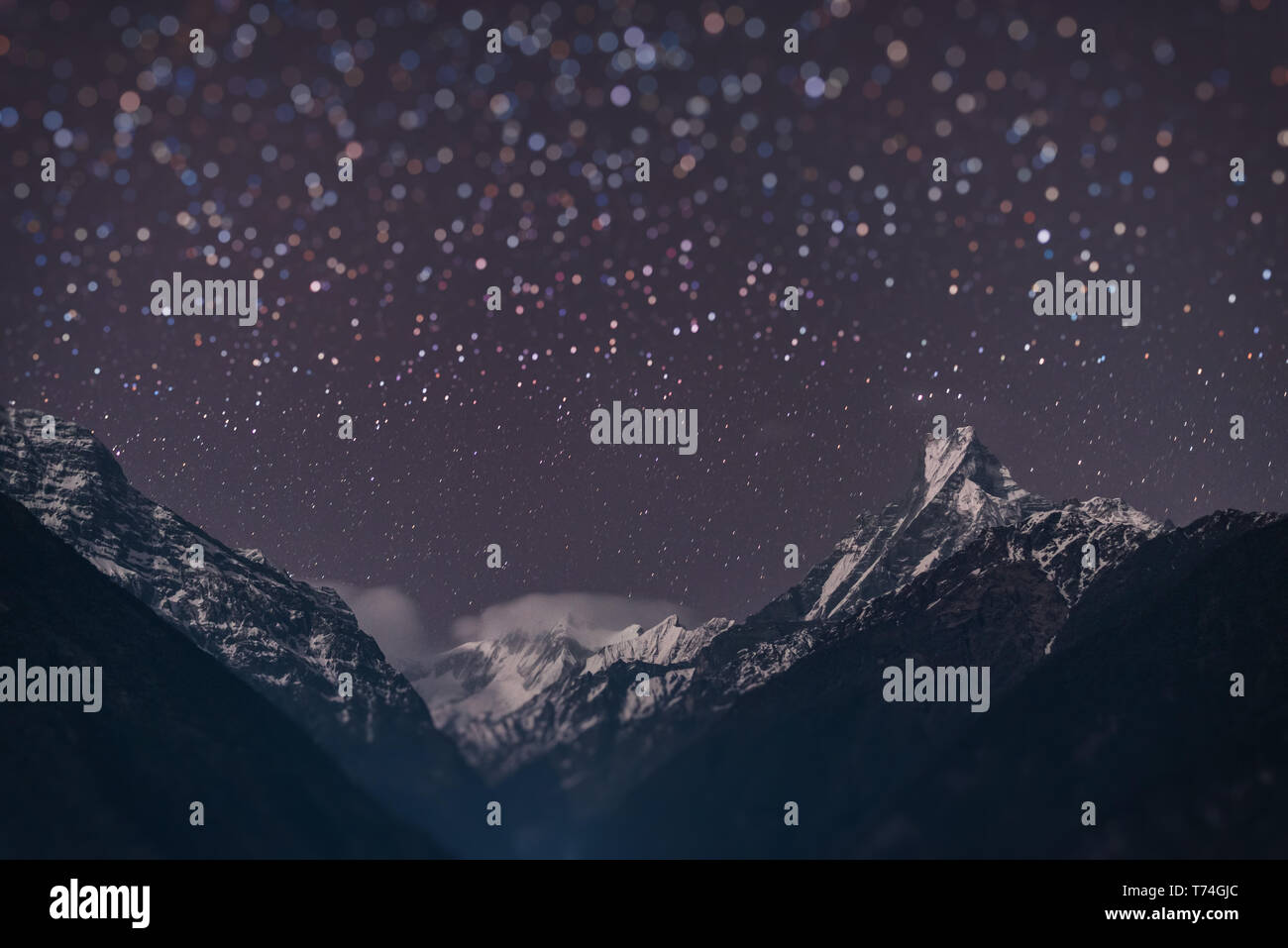 Annapurna range with Machhapuchhre mountain peak  at night with miniature blur star. Stock Photo