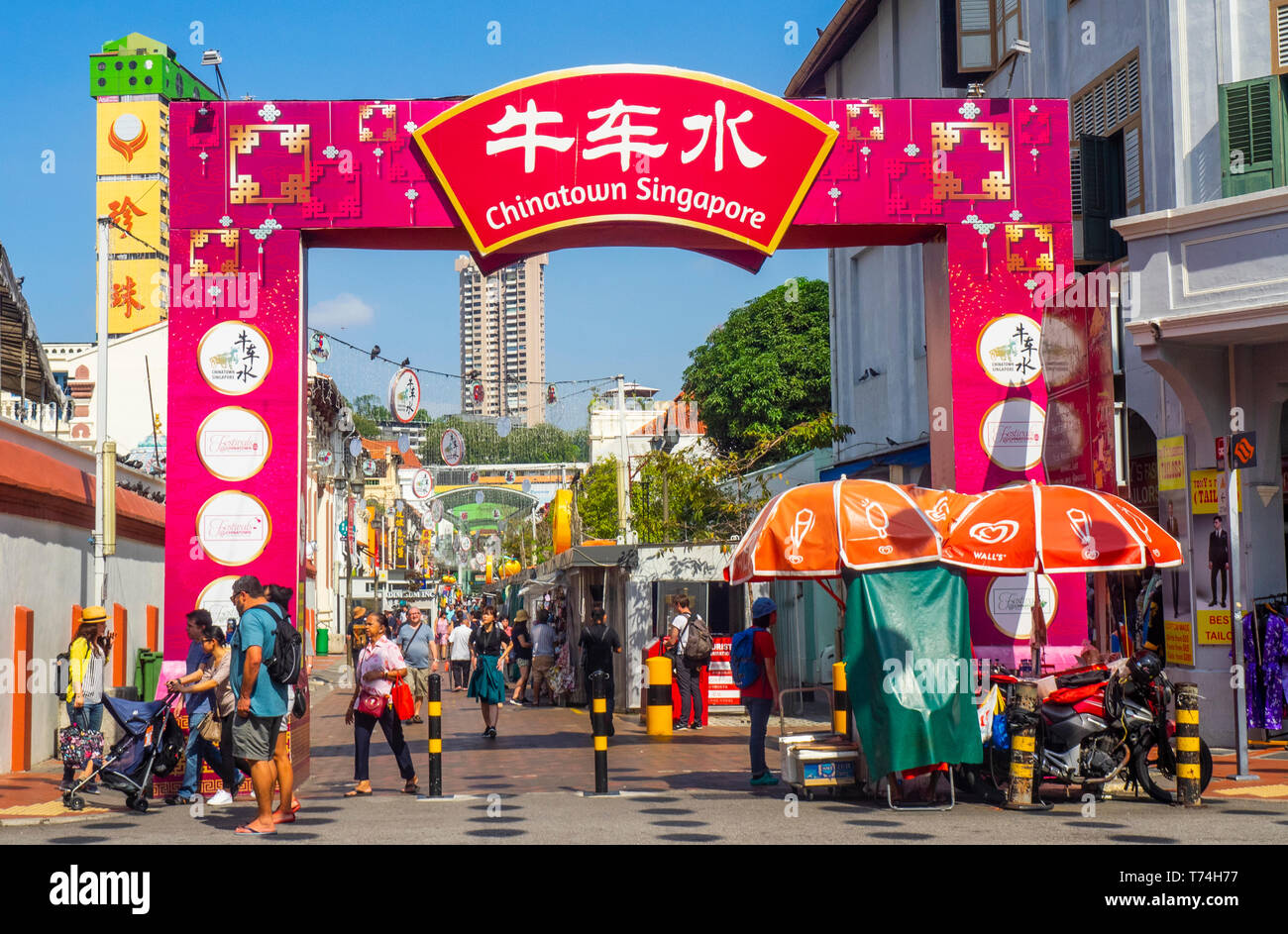 Tourists at gateway arch entrance to Pagoda Street Chinatown Singapore. Stock Photo
