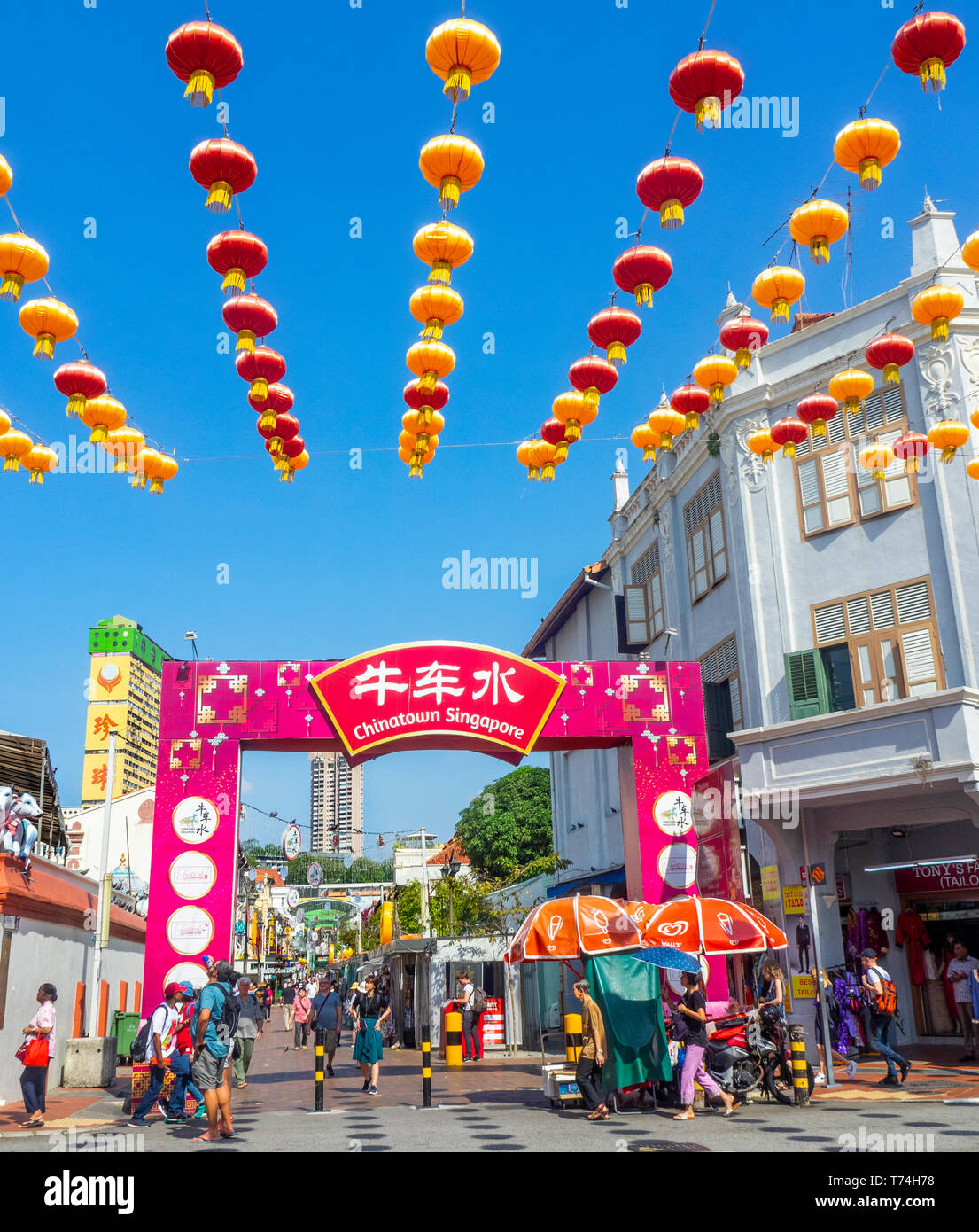 Chinese red lanterns for Chinese New Year celebrations  and tourists at gateway arch entrance to Pagoda Street Chinatown Singapore. Stock Photo