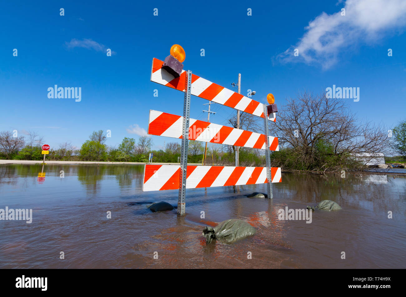 Partially submerged "Road closed" barriers blocking traffic in Utica
