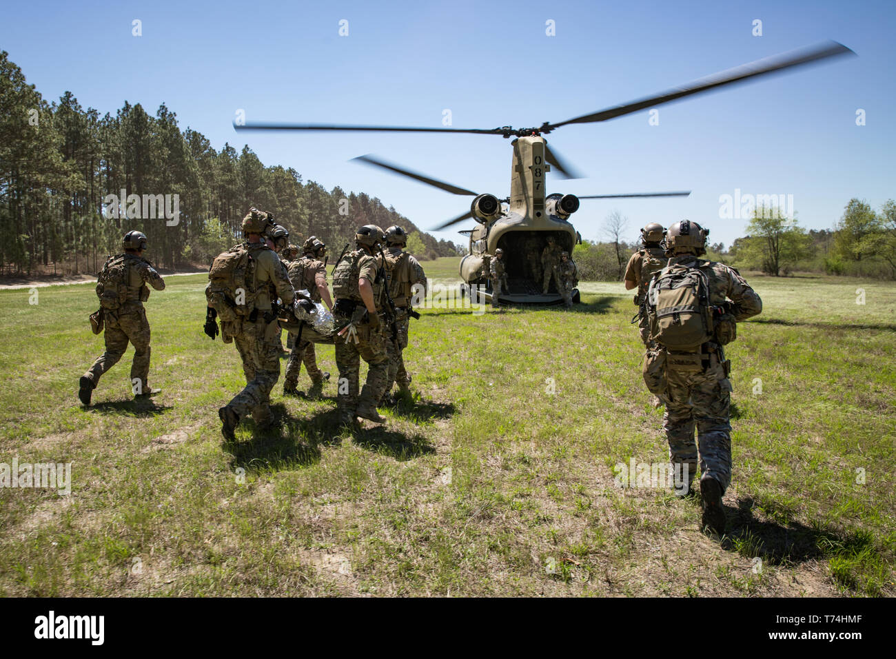 Green Berets assigned to 3rd Special Forces Group (Airborne) enter the back of a CH-47 Chinook helicopter after conducting a raid during a routine training mission April 10, 2019 at Camp Mackal, NC. The Green Berets focused on utilizing new communication systems and casualty care during the training mission. (U.S. Army Photo by Sgt. Steven Lewis) Stock Photo
