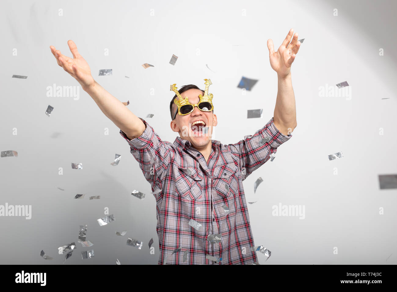 People, holidays and party concept - funny guy in glasses dancing in confetti on white background Stock Photo - Alamy People, holidays and party concept - funny guy in glasses dancing in confetti on white background Stock Photo - Alamy