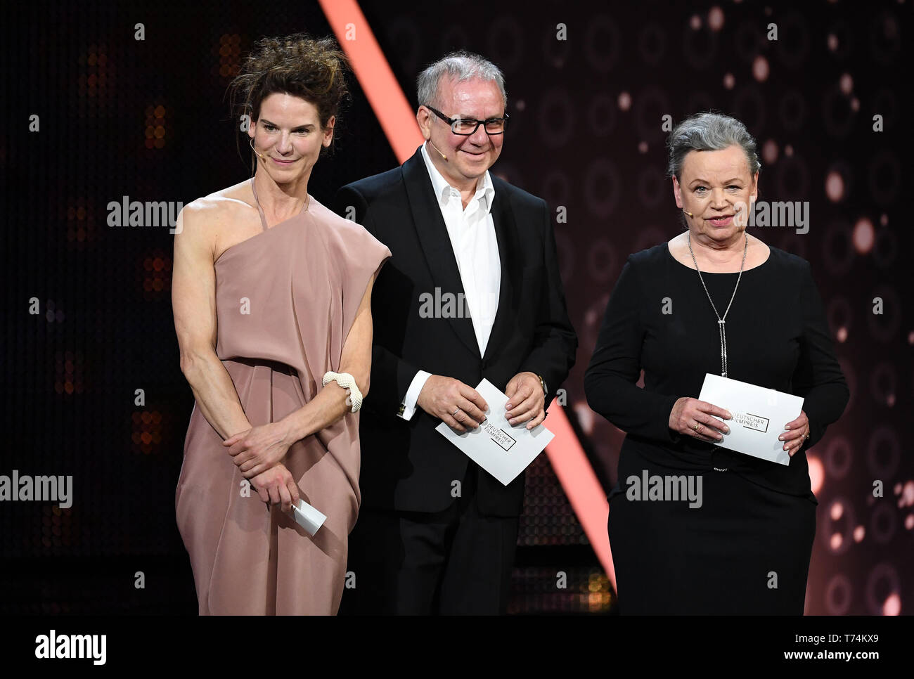 Berlin, Germany. 03rd May, 2019. The actors Ursula Werner (r), Bibiana Beglau and Joachim Krol, give the laudatio in the category 'Best Director' at the 69th German Film Award 'Lola'. Credit: Britta Pedersen/dpa-Zentralbild/dpa/Alamy Live News Stock Photo
